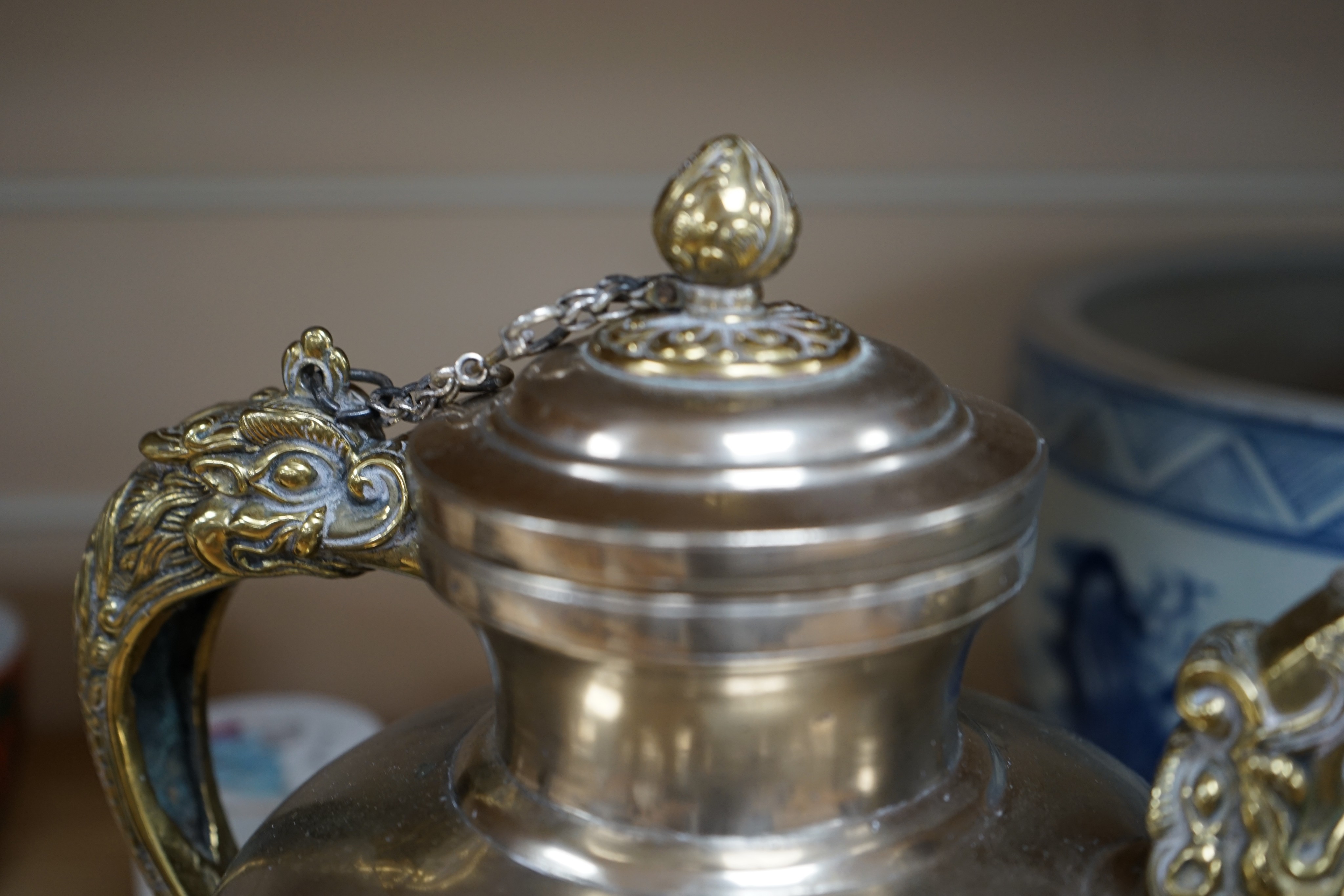 A late 19th/early 20th century Tibetan paktong, bronze and silver mounted teapot, 24cm